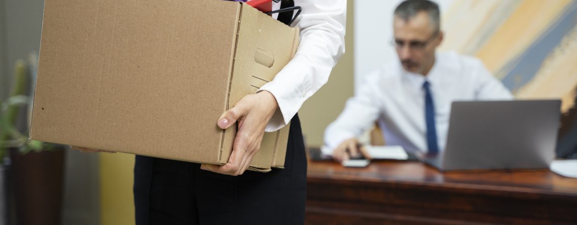 woman-carrying-cardboard-box-side-view-1140x445